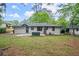 Backyard with a grassy lawn and a view of the back of the home, featuring a small patio at 140 Larose Se Cir, Marietta, GA 30060
