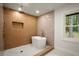 Luxurious bathroom featuring a soaking tub, custom tile work, and natural light at 140 Larose Se Cir, Marietta, GA 30060