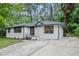 Ranch style home showcasing updated landscaping and a concrete driveway at 140 Larose Se Cir, Marietta, GA 30060