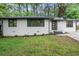 Newly renovated home with white painted brick, updated windows and refreshed landscaping at 140 Larose Se Cir, Marietta, GA 30060