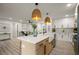Beautiful open-concept kitchen with stainless appliances, a large island and modern pendant lighting at 140 Larose Se Cir, Marietta, GA 30060