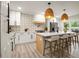 A modern kitchen featuring white cabinets, a kitchen island with seating, and stylish pendant lighting at 140 Larose Se Cir, Marietta, GA 30060