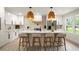 The renovated kitchen features a large island, white cabinets, and trendy backsplash at 140 Larose Se Cir, Marietta, GA 30060
