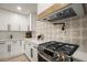 Well-equipped kitchen features stainless steel range, stylish backsplash, and sleek white countertops at 140 Larose Se Cir, Marietta, GA 30060