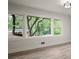 Bright living room with large windows bringing nature indoors and beautiful wood-look floors at 140 Larose Se Cir, Marietta, GA 30060