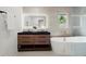 Contemporary bathroom with a double sink vanity, soaking tub and bright natural light at 1863 Trumbull Dr, Atlanta, GA 30338