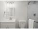 Modern bathroom with a white vanity, framed mirror, and a glass-enclosed shower at 1863 Trumbull Dr, Atlanta, GA 30338