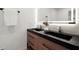 Modern bathroom featuring double sink vanity, black hardware, and a large, lighted mirror at 1863 Trumbull Dr, Atlanta, GA 30338