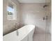 Spa-like bathroom featuring a soaking tub, walk-in shower, and sleek fixtures at 1863 Trumbull Dr, Atlanta, GA 30338