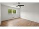 Bright, minimalist bedroom featuring hardwood floors, a modern ceiling fan, and natural light at 1863 Trumbull Dr, Atlanta, GA 30338