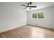 Airy bedroom featuring hardwood floors, a modern ceiling fan, and natural light at 1863 Trumbull Dr, Atlanta, GA 30338