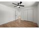 Neutral bedroom features hardwood floors, ceiling fan, closet and doorway to hallway at 1863 Trumbull Dr, Atlanta, GA 30338