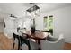 Open-concept dining area with modern lighting, hardwood floors, and large windows offering natural light at 1863 Trumbull Dr, Atlanta, GA 30338
