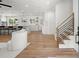 Inviting entryway with wood floors, a modern staircase, and an open view to the kitchen at 1863 Trumbull Dr, Atlanta, GA 30338