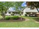 Charming white two-story home with lush landscaping and a well-manicured lawn at 1863 Trumbull Dr, Atlanta, GA 30338
