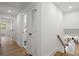 Second story hallway with white paint, wood floors and a view into the first floor living spaces at 1863 Trumbull Dr, Atlanta, GA 30338