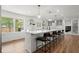 Modern kitchen with white cabinets, a large island with seating, and stainless steel appliances at 1863 Trumbull Dr, Atlanta, GA 30338