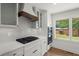 Modern kitchen with gas range, oven, and white cabinets, offering a sleek, functional space at 1863 Trumbull Dr, Atlanta, GA 30338