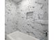 Close up of a modern marble shower featuring a built-in niche for storage at 1863 Trumbull Dr, Atlanta, GA 30338