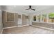 Bright sunroom featuring brick accent wall, multiple windows, and light wood-look flooring at 1863 Trumbull Dr, Atlanta, GA 30338