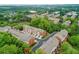 An aerial view shows multiple townhouse buildings with brick and siding exteriors surrounded by mature trees at 4888 Colchester Se Ct # 3, Atlanta, GA 30080