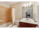 Well-lit bathroom features a tub-shower combination and vanity with a cherry wood cabinet at 4888 Colchester Se Ct # 3, Atlanta, GA 30080