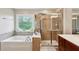Elegant bathroom featuring a soaking tub with tile surround and glass-enclosed shower at 4888 Colchester Se Ct # 3, Atlanta, GA 30080