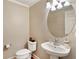 Charming powder room featuring a pedestal sink, oval mirror, and neutral wall paint at 4888 Colchester Se Ct # 3, Atlanta, GA 30080