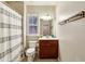 A cozy bathroom has a vanity with storage and a shower-tub with a curtain at 4888 Colchester Se Ct # 3, Atlanta, GA 30080