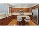 Well-equipped kitchen with wooden cabinetry, stainless steel appliances, granite counters, and a breakfast bar at 4888 Colchester Se Ct # 3, Atlanta, GA 30080