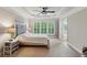 Spacious main bedroom featuring a tray ceiling, large windows, plush carpet, and soft neutral paint at 4888 Colchester Se Ct # 3, Atlanta, GA 30080