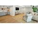 A cozy basement with a kitchenette, wet bar, hardwood floors, and comfortable seating around a large rug at 520 Flying Scot Way, Alpharetta, GA 30005