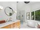 Bright bathroom featuring a glass shower, soaking tub, dual sinks and luxury finishes at 520 Flying Scot Way, Alpharetta, GA 30005