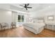 Large bedroom featuring a tray ceiling, ceiling fan, and lots of natural light at 520 Flying Scot Way, Alpharetta, GA 30005