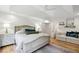 Spacious bedroom featuring a tray ceiling, large windows, and cozy seating area with stylish decor at 520 Flying Scot Way, Alpharetta, GA 30005