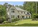 Stunning exterior view of a bright, two-story home with pristine landscaping and a well-manicured lawn and beautiful trees at 520 Flying Scot Way, Alpharetta, GA 30005