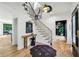 Inviting foyer with hardwood floors, staircase, artwork, and black accents at 520 Flying Scot Way, Alpharetta, GA 30005