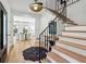Stunning foyer with hardwood floors, modern lighting, and grand staircase with iron railing at 520 Flying Scot Way, Alpharetta, GA 30005