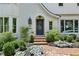 Charming front entrance with brick steps, detailed door, manicured landscaping and mature plantings at 520 Flying Scot Way, Alpharetta, GA 30005