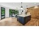 Modern kitchen with marble countertops, a large island, and natural wood cabinets at 520 Flying Scot Way, Alpharetta, GA 30005