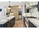 Stylish kitchen showcases a center island with white marble countertops, designer cabinets, and modern appliances at 520 Flying Scot Way, Alpharetta, GA 30005