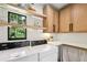Bright laundry area with white cabinets, countertops, a window with nature views and modern washer and dryer at 520 Flying Scot Way, Alpharetta, GA 30005