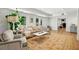 Sunlit living room with hardwood floors, a neutral color scheme, french doors, and a decorative area rug at 520 Flying Scot Way, Alpharetta, GA 30005