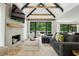 Inviting living room featuring vaulted ceilings, exposed wood beams, and a cozy fireplace at 520 Flying Scot Way, Alpharetta, GA 30005