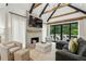 Comfortable living room featuring a stone fireplace, vaulted ceilings, and access to the deck at 520 Flying Scot Way, Alpharetta, GA 30005