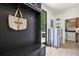 Mudroom with coat hooks, storage bench, and adjacent laundry area, providing a convenient entry point at 520 Flying Scot Way, Alpharetta, GA 30005