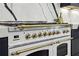 Close up of the modern, white oven with brass accents at 520 Flying Scot Way, Alpharetta, GA 30005