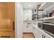 Walk-in pantry with built-in shelving, cabinets, and countertop space for small appliances at 520 Flying Scot Way, Alpharetta, GA 30005