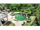 Aerial view of backyard pool and spa with rock waterfall feature, surrounded by lush landscaping at 520 Flying Scot Way, Alpharetta, GA 30005