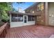 Back deck view of the house with a screened in porch and brick exterior at 2360 Elon Way, Decatur, GA 30033